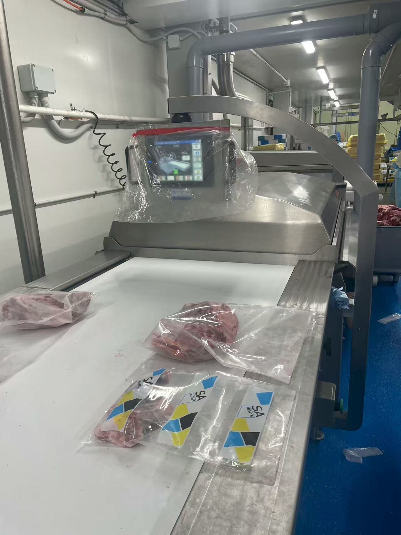 Packed meat products on processing line